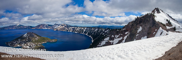 Even in July, snow covers the rim of Crater Lake.  Formed in the caldera of an extinct volcano, it is the deepest lake in the United States.  This depth accounts for the rich blue color of the water.