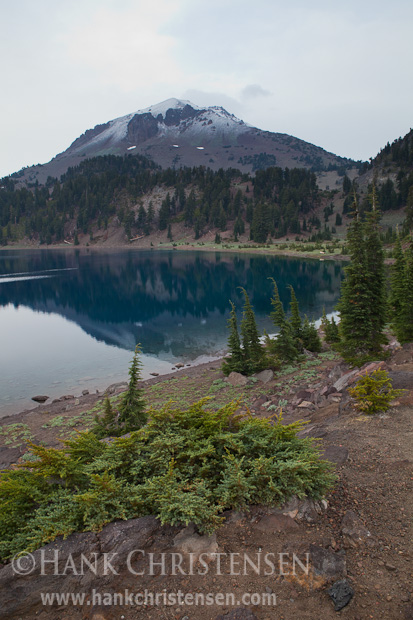 Mt. Lassen is reflected in Lake Helen after a morning snow shower, Lassen National Park, California