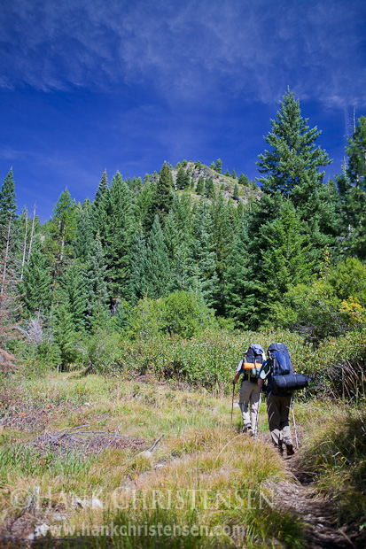 Two backpackers ascend the steep Little Kettle Creek trail to Crater Lake, Eagle Cap Wilderness, Oregon