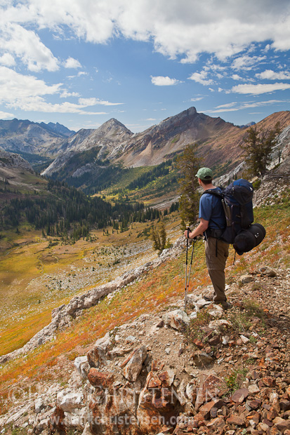 A backpacker pauses to admire the impressive view of Jackson Peak and the Imnaha River Valley, Eagle Cap Wilderness, Oregon