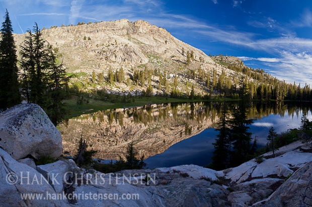 A calm lakes reflects the surrounding cliffs in early morning, Ten Lakes, Yosemite National Park