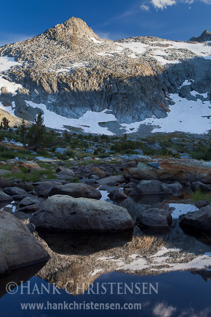 Mt. Davis is reflected amongst the boulders in Davis Lake, Ansel Adams Wilderness