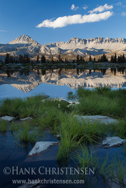 Mountains are reflected in the smooth surface of Davis Lake at sunset, Ansel Adams Wilderness