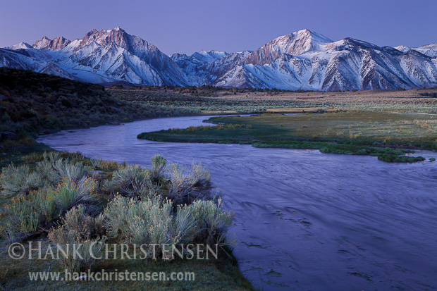 Moments before the sun rises, Hot Creek reflects the cool glow of snow covered peaks