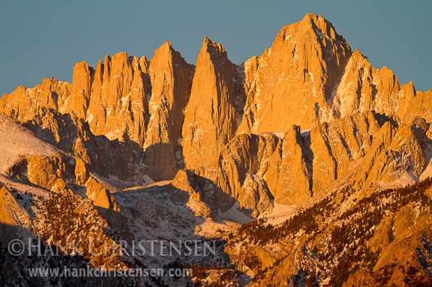 Moments after the sun rises over the Nevada desert, the peak of Mt. Whitney glows a bright orange