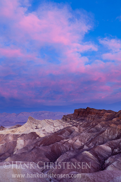 Clouds explode with light over the multi-colored rock at Zabriskie Point, Death Valley National Park