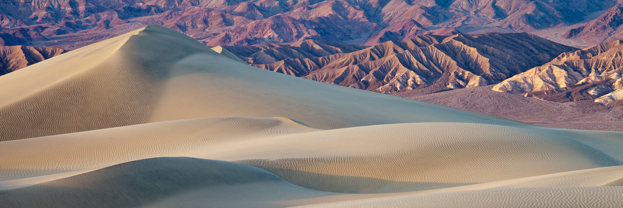 Mountains rise beyond the sand dunes of Mesquite Flat, Death Valley National Park