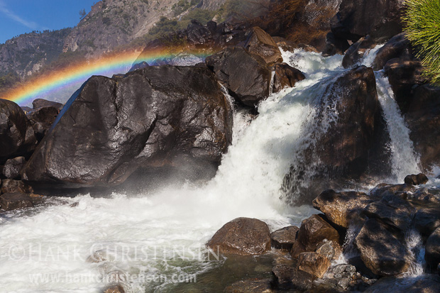 The spray from Wapama Falls creates a rainbow as it rushes into the Hetch Hetchy Reservoir, Yosemite National Park