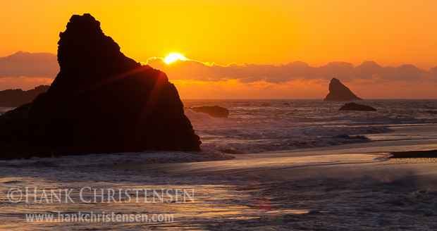 The sun sets behind offshore sea stacks, Harris Beach State Park