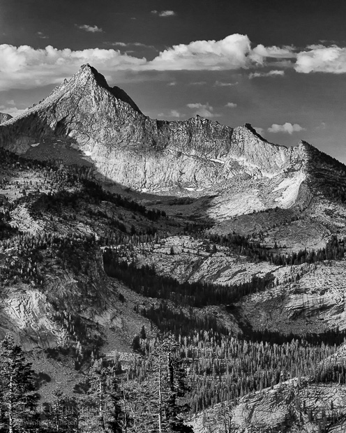 The rising sun side lights Mt. Clark and casts sharp shadows across its face, Yosemite National Park