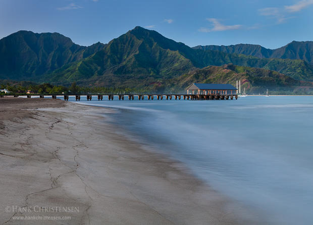 In the moments before sunrise, the sea washes a beach clean in Hanalei Bay, Kauaii