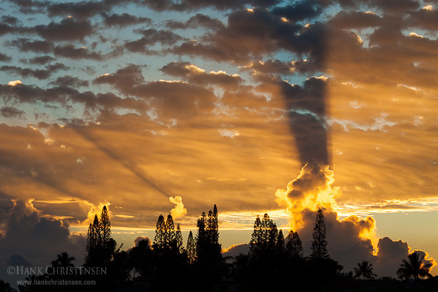 Dramatic shadows play across the thick clouds at sunrise, Kauai, Hawaii