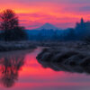 Sunrise lights up the clouds behind Mt. Hood, reflected in the still waters of Salmon Creek, Vancouver, WA.